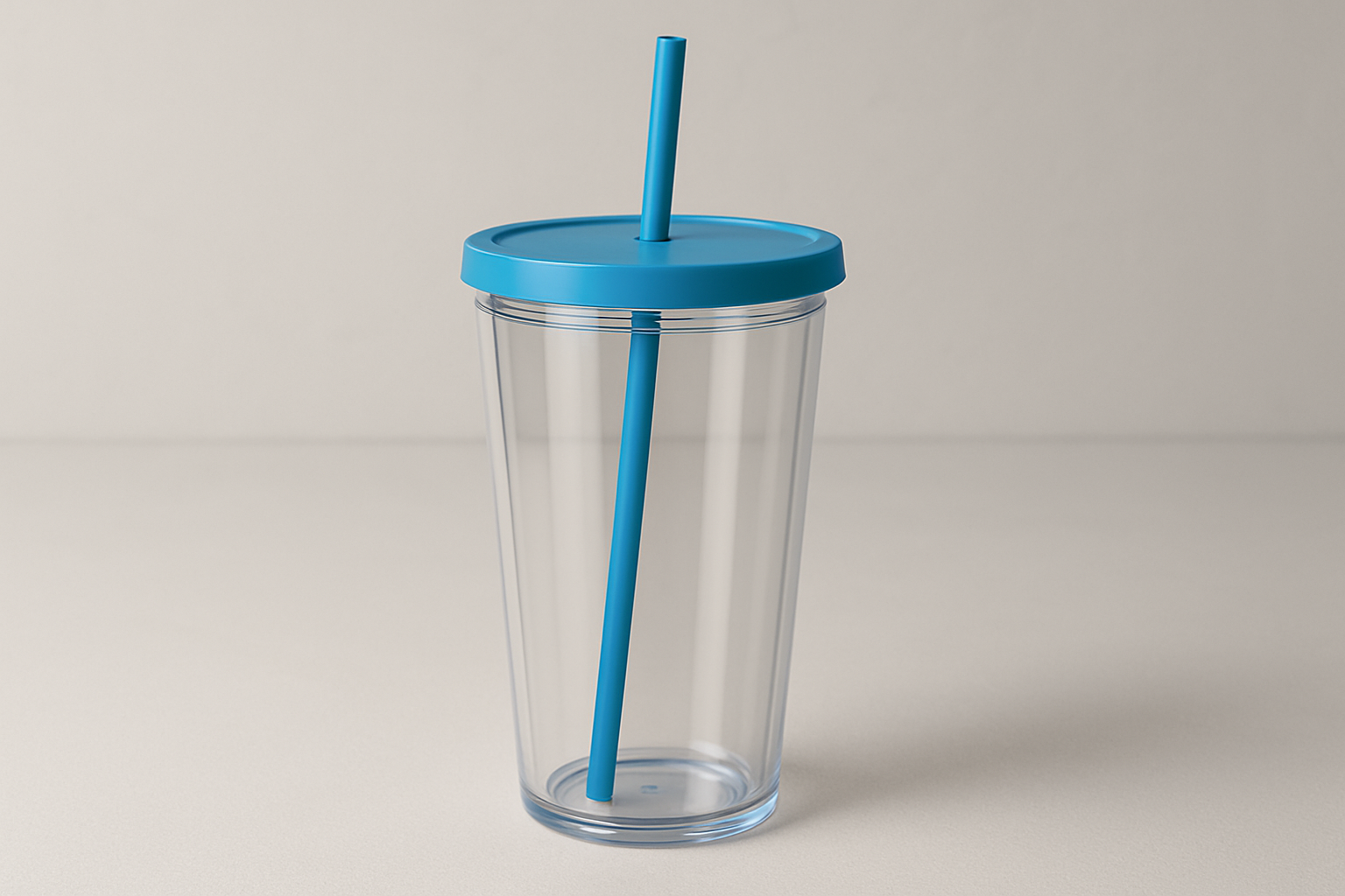 clear plastic 16oz tumbler with a blue lid and blue straw